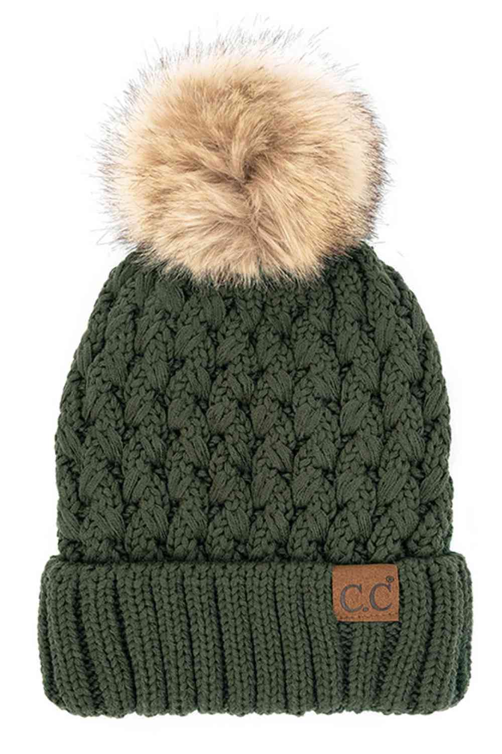 Deep green knitted beanie with fluffy pom-pom and C.C patch on ribbed cuff.