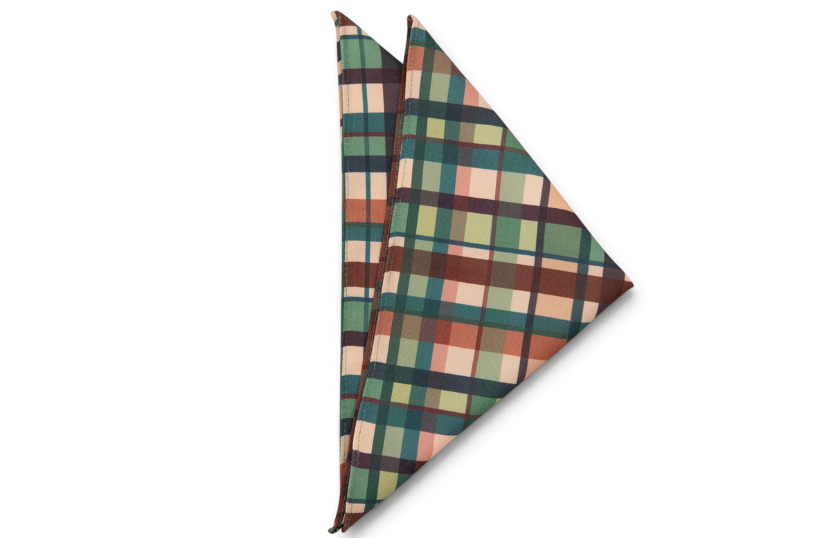 Plaid pocket square in green, tan, and red with dark lines, folded square