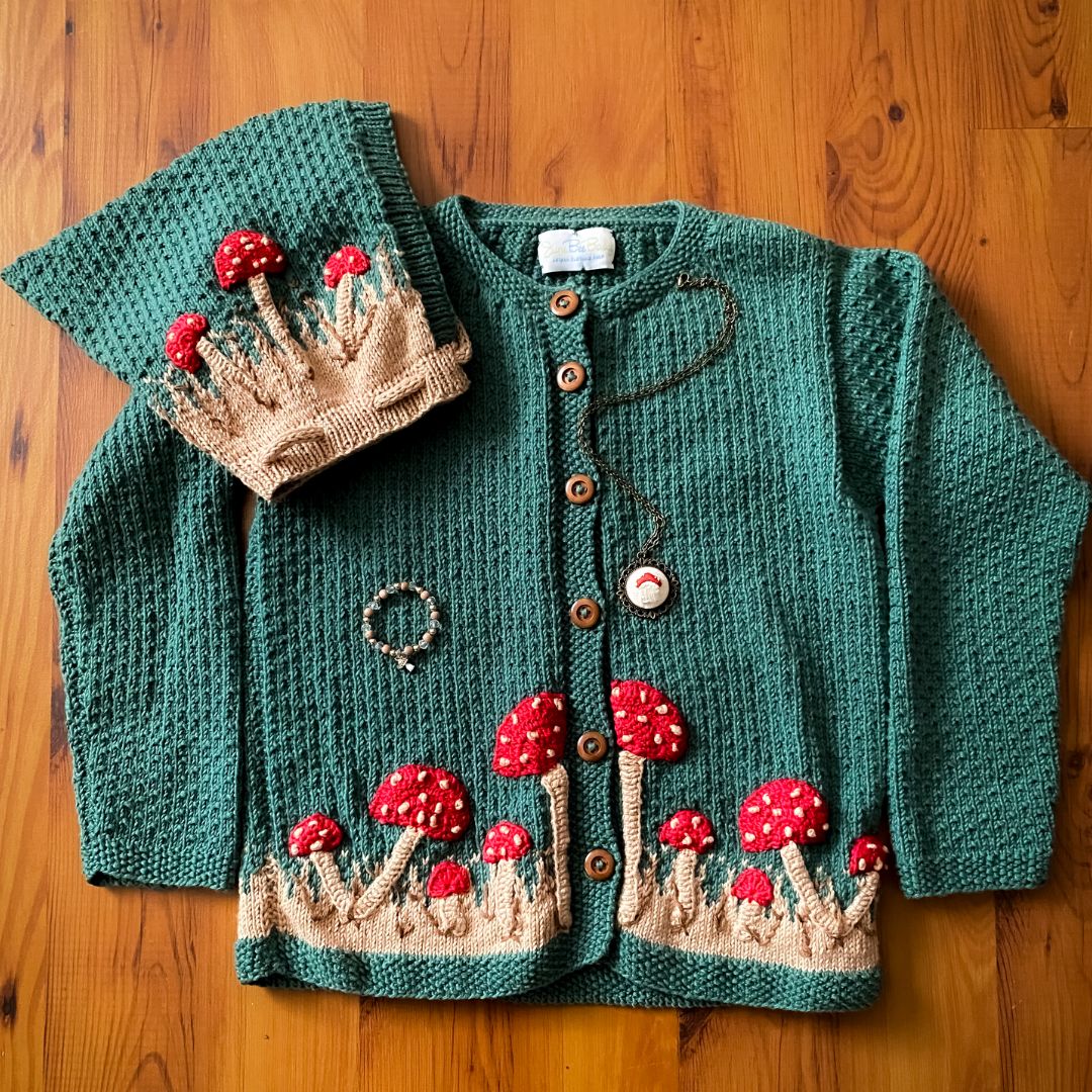 Hunter green knit cardigan with red mushroom applique and brown button front, long sleeves