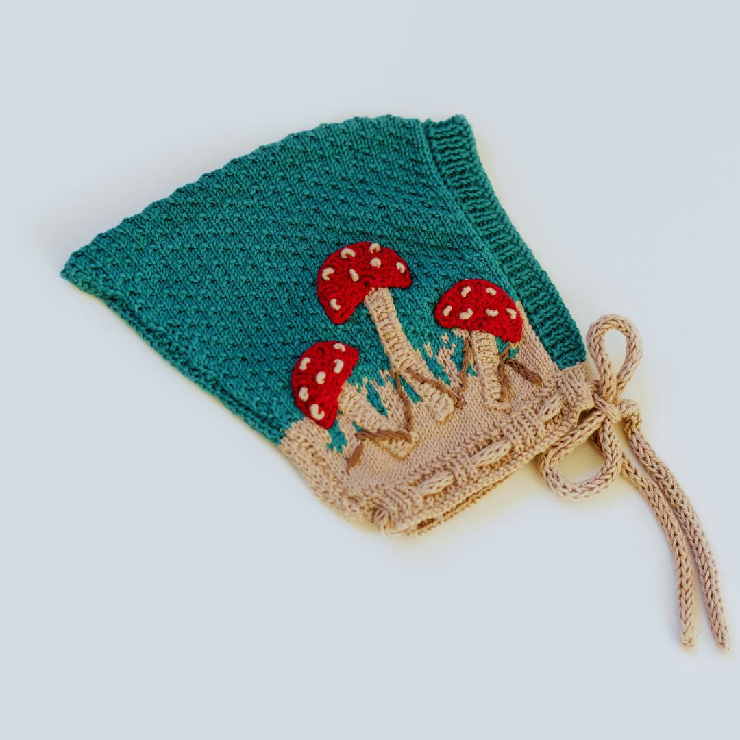 Hunter green knit pixie hat with red mushrooms and tan applique cuff