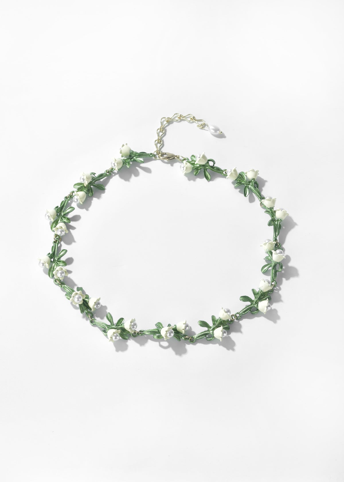 Lily of the Valley necklace with small white flowers and green leaves on a silver-tone chain