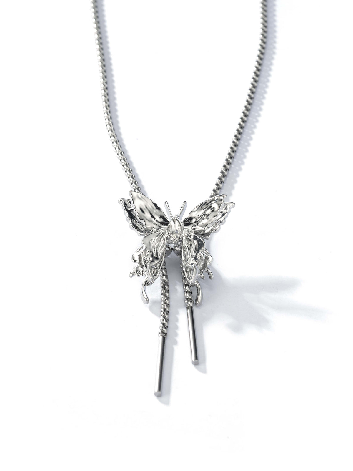 Silver-tone necklace with an ornate butterfly pendant and long dangling accents