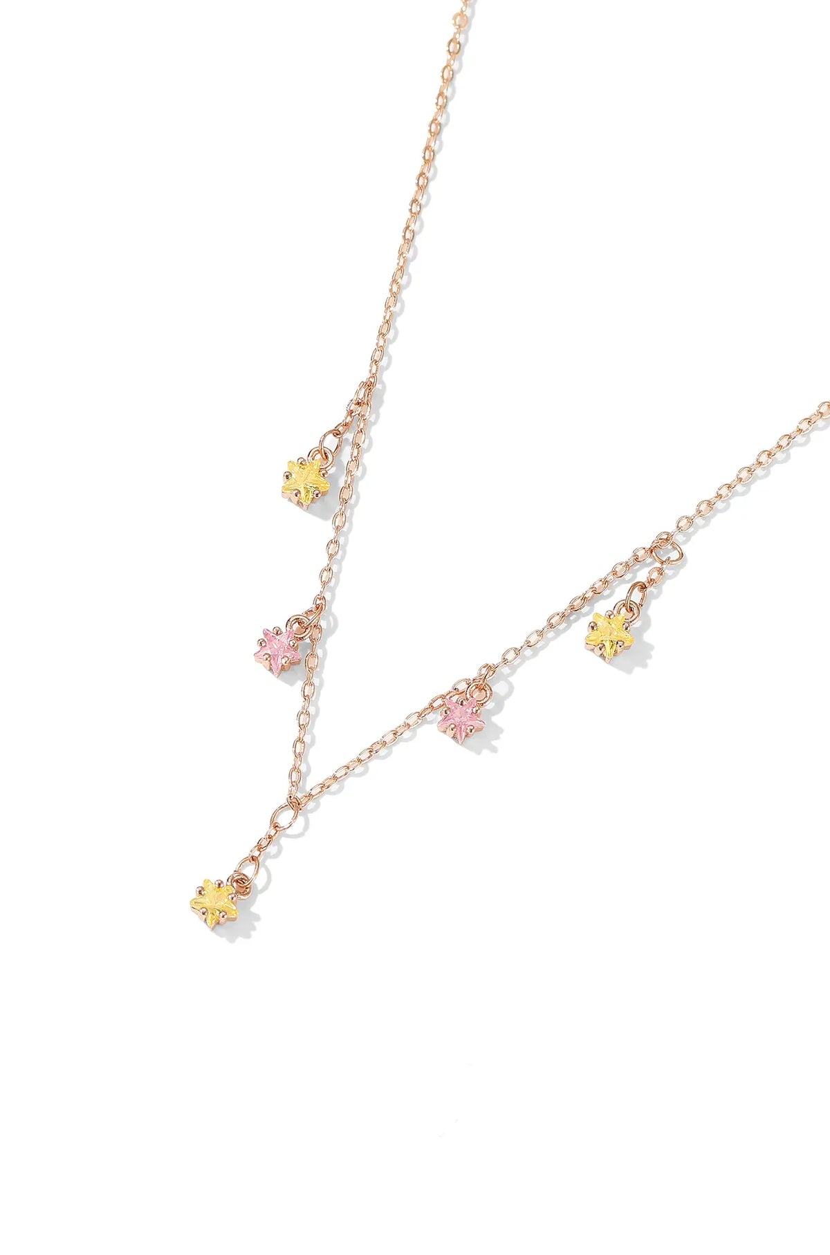 Rose gold pendant necklace with five small pink and yellow flower charms.