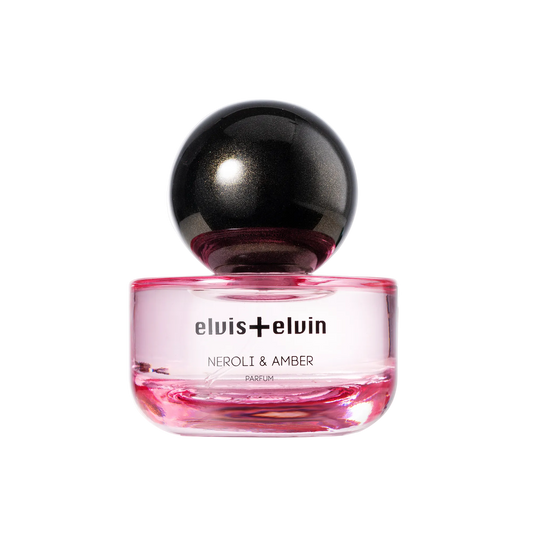 Glass neroli & amber parfum bottle with pink liquid and black dome cap