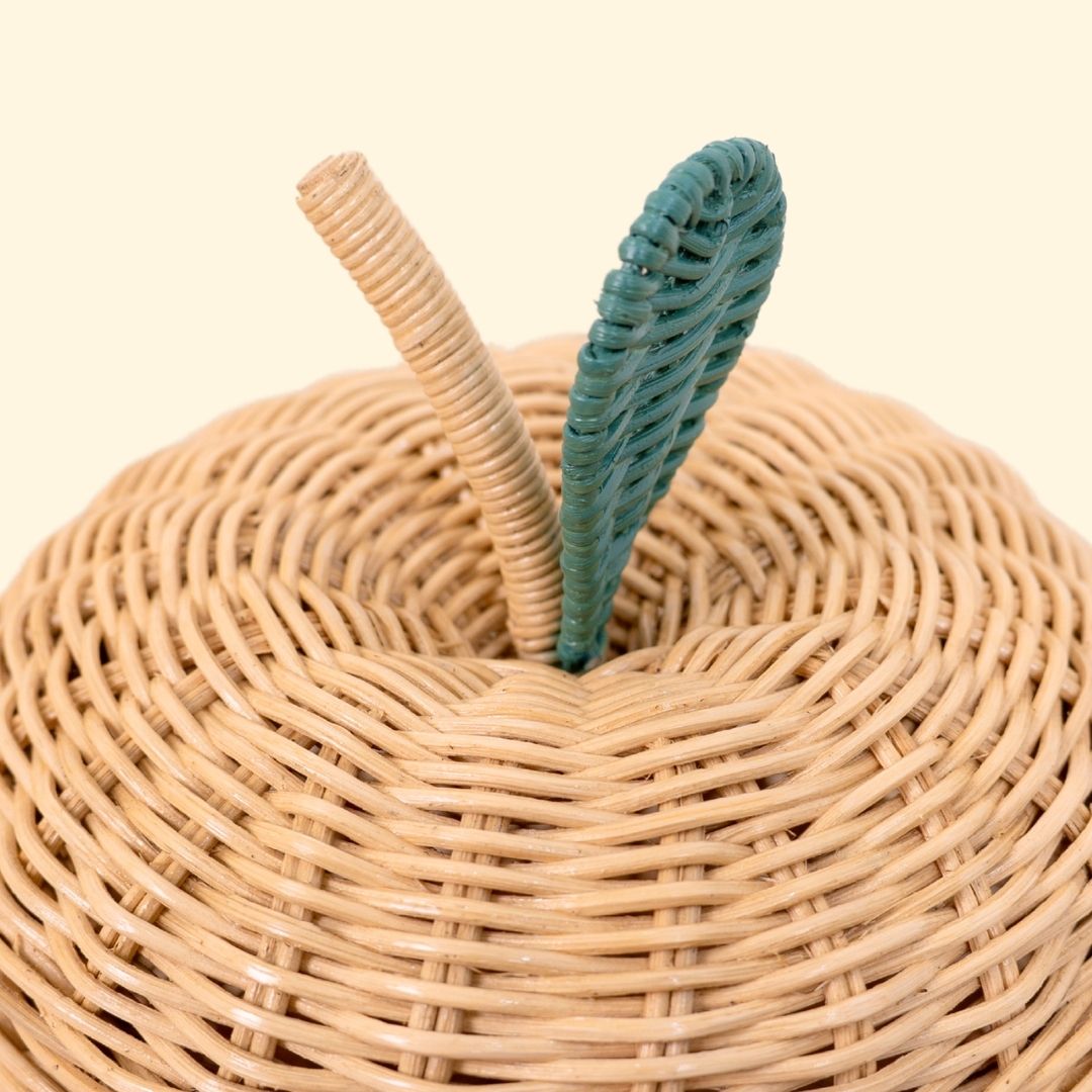Close-up of the woven rattan lid, stem, and teal leaf detail