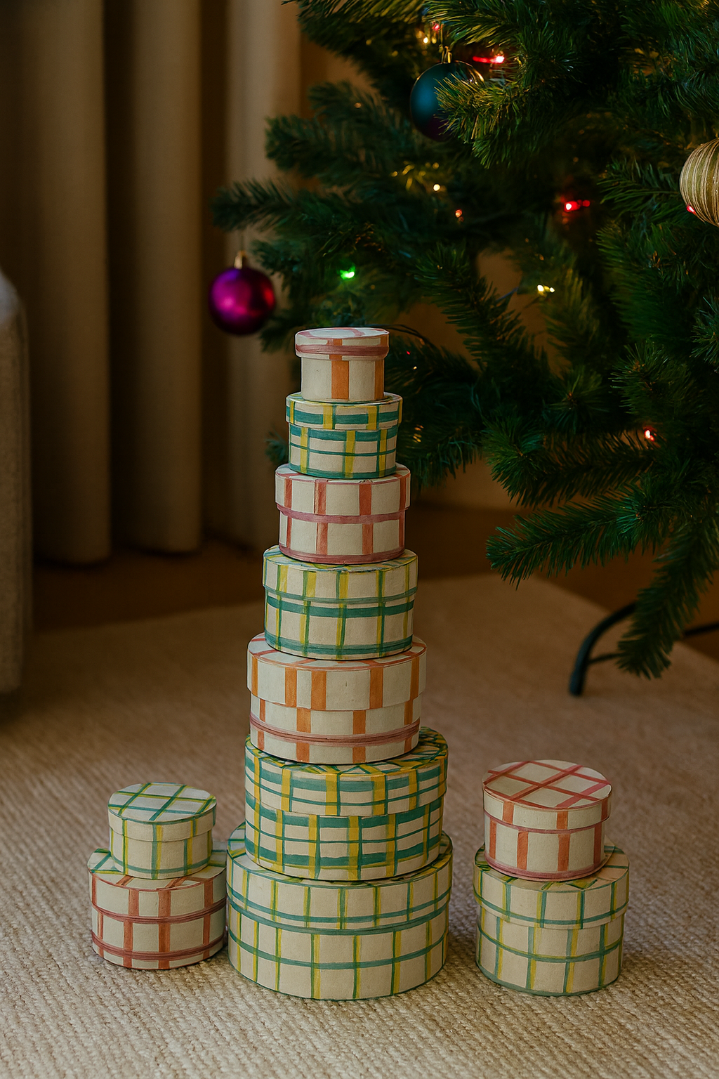 Stacked round handmade recycled paper nesting gift boxes in green and red grid