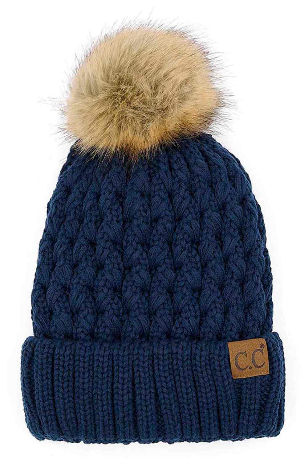 Navy knitted beanie with fluffy pom-pom and C.C patch on ribbed cuff.