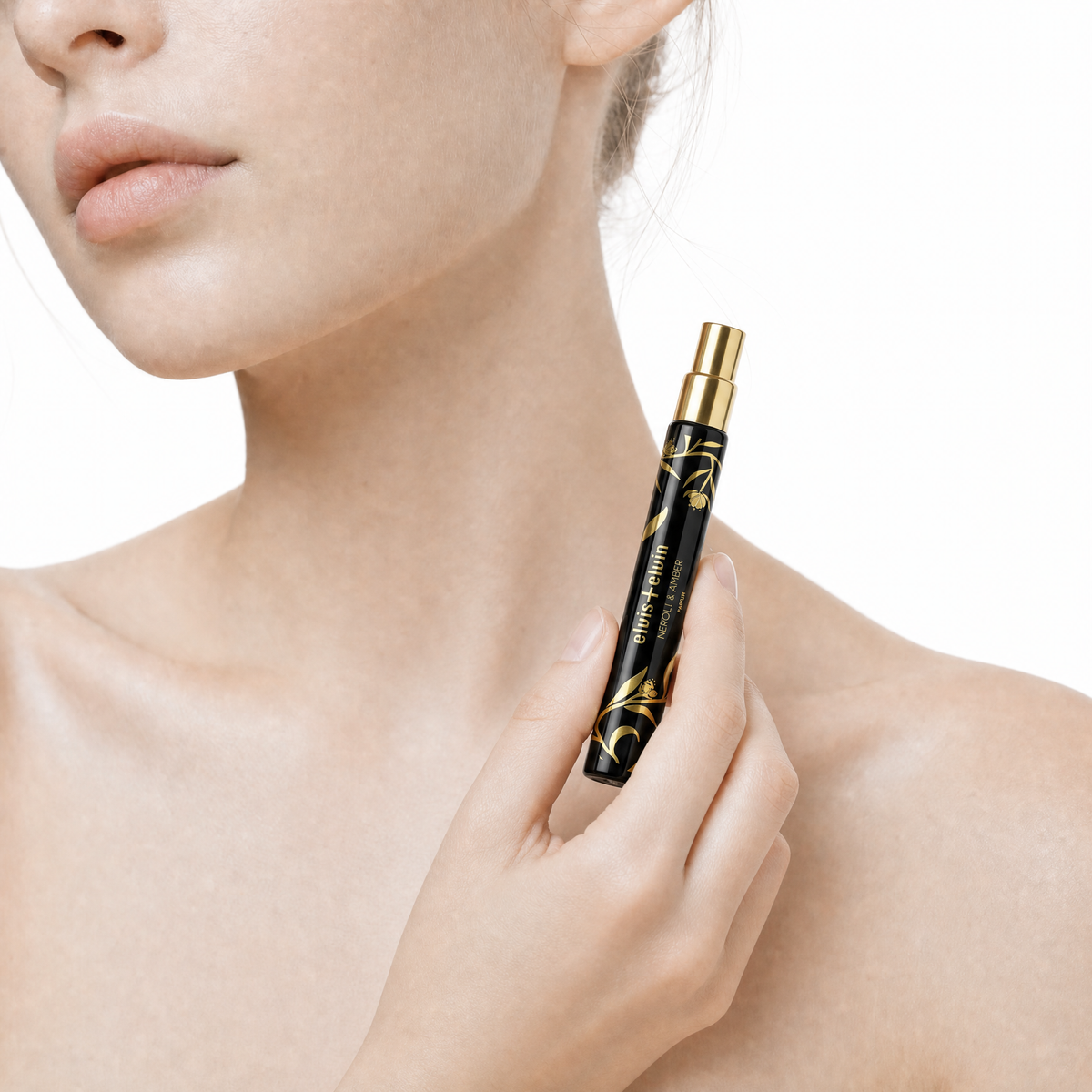 Perfume roller pen with gold cap near neck of person
