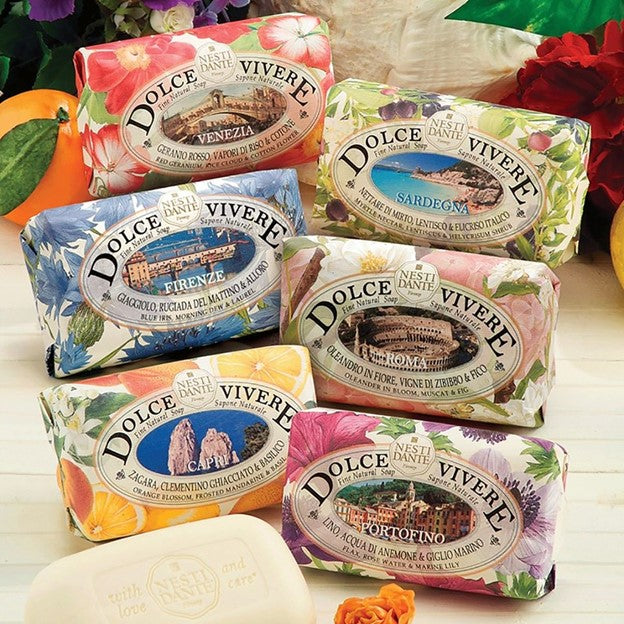 Assorted wrapped Dolce Vivere bar soaps with floral labels in multiple colors