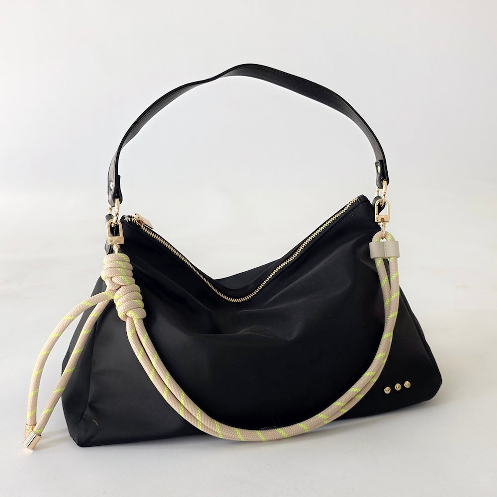 Black nylon slouchy shoulder bag with light green rope strap and gold hardware studs