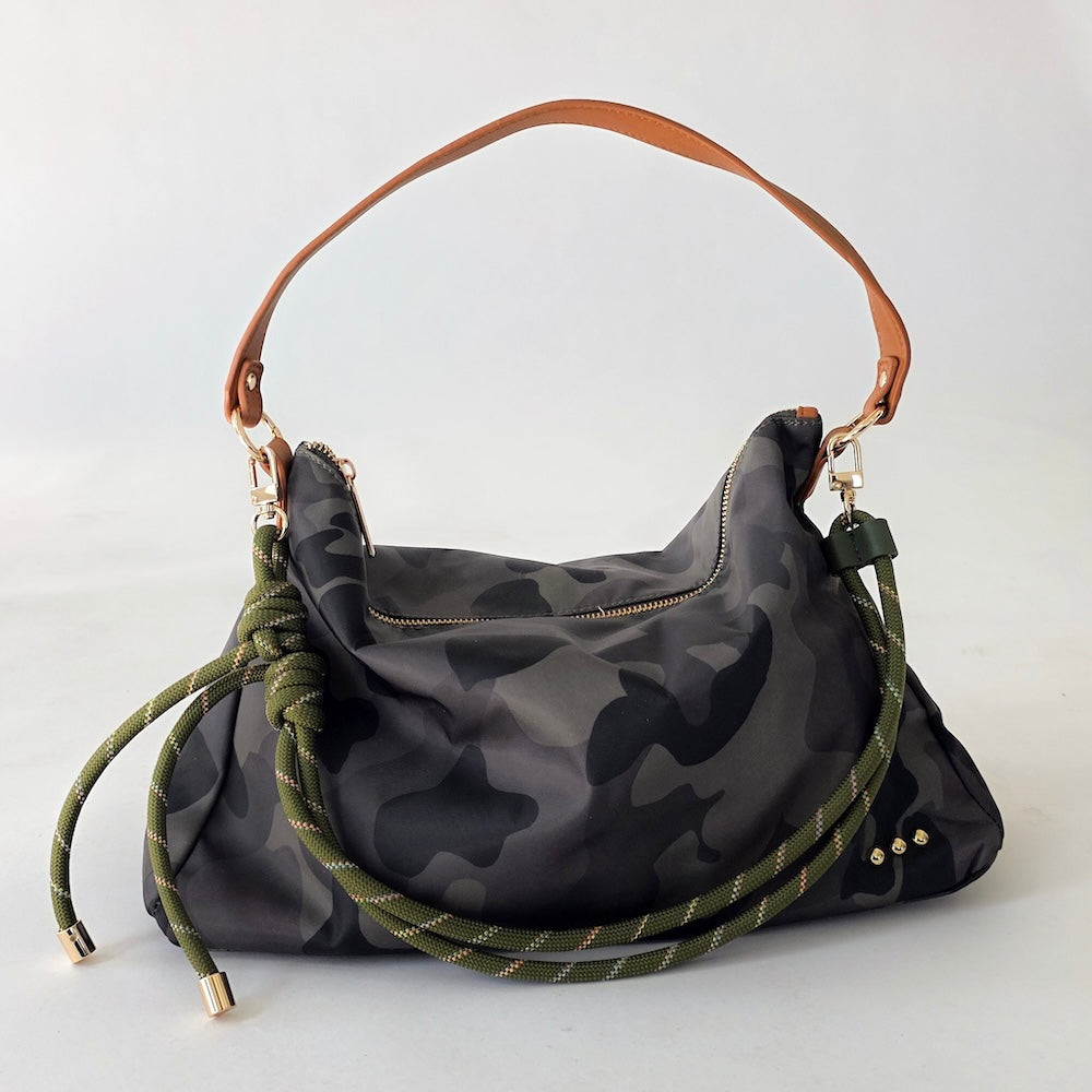Nikki nylon slouchy shoulder bag with dark camo print, brown handle, and braided strap