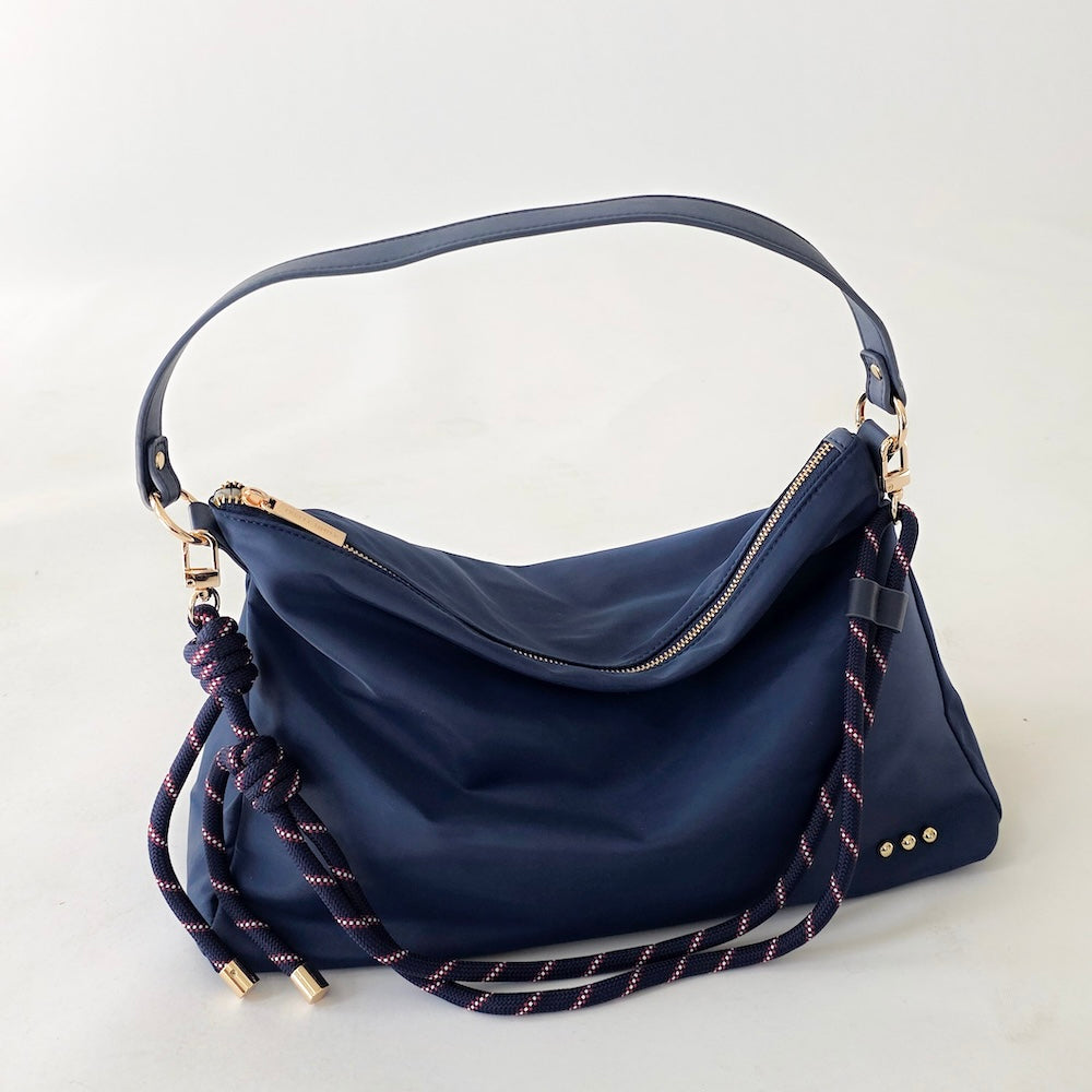 Nikki nylon slouchy shoulder bag in navy with gold hardware and braided strap details