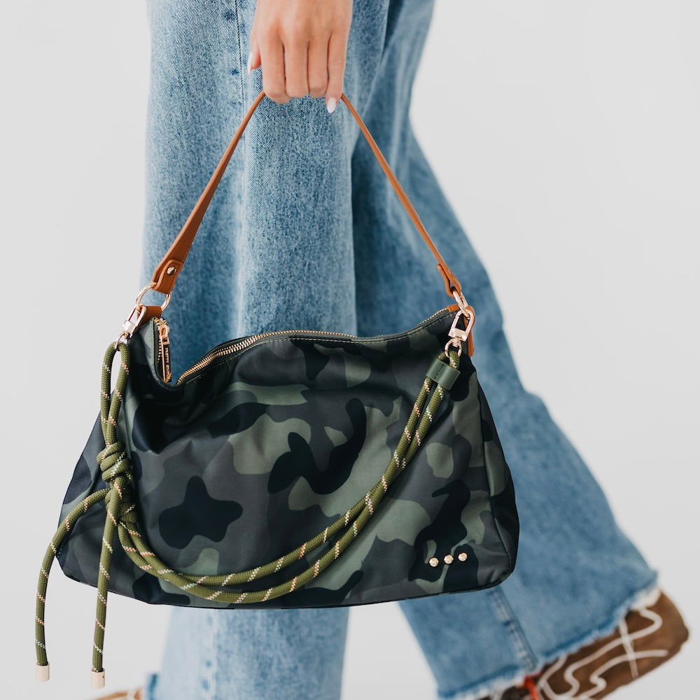 Dark camo nylon slouchy shoulder bag with green rope strap and brown leather accents