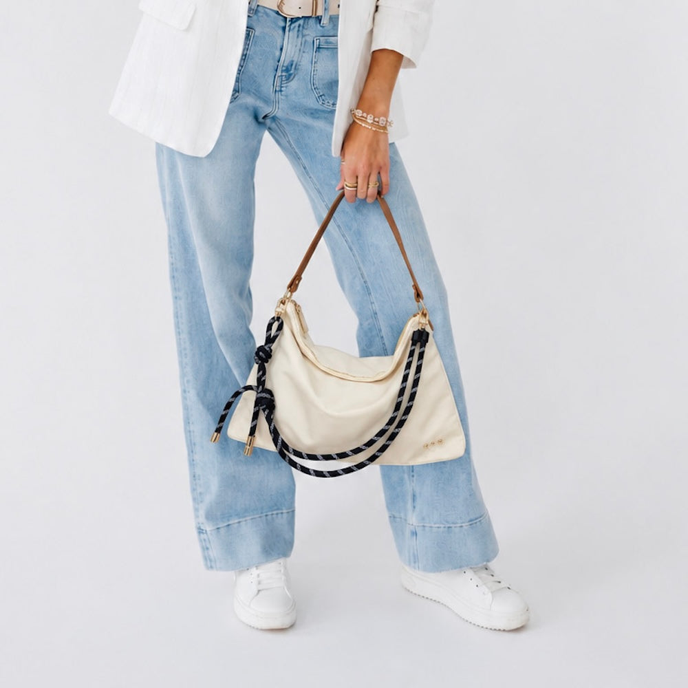 Nikki nylon slouchy shoulder bag in cream with black-and-navy rope strap