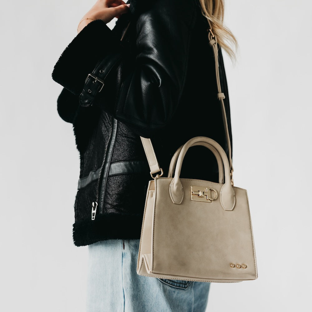 Oat suede small tote bag with top handles, metal clasp, and stud accents