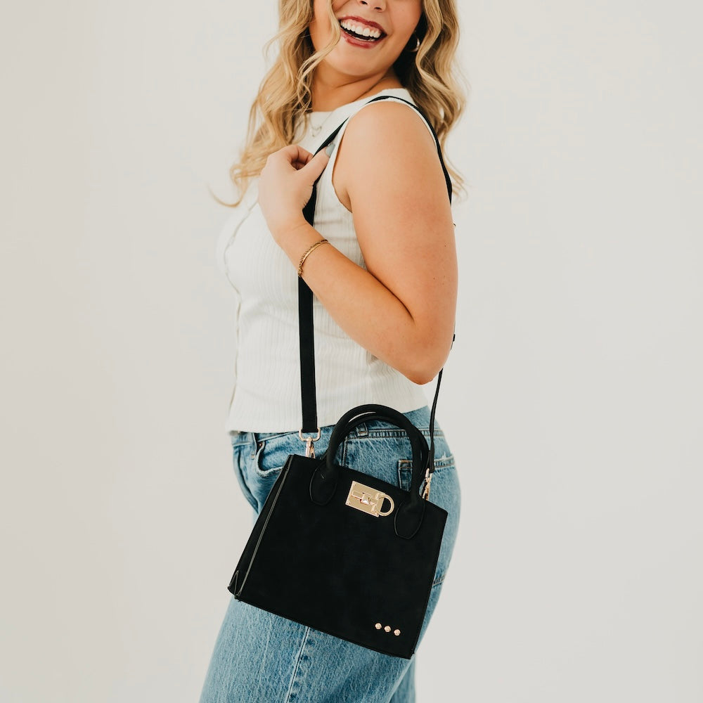 Black suede small tote bag with top handle and shoulder strap
