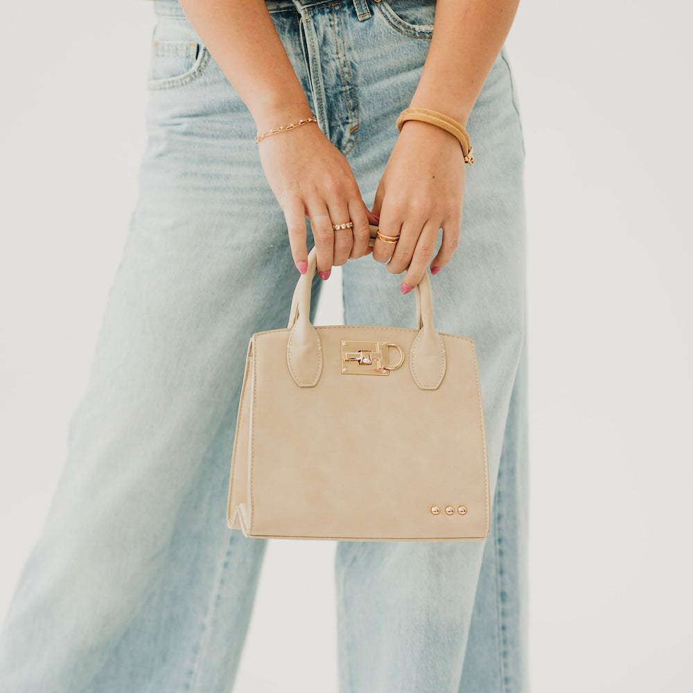 Oat suede small tote bag with top handles and metal buckle front