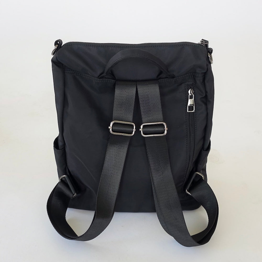 Nylon backpack purse in black, back view with adjustable straps and hanging loop