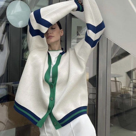 Cream cardigan with V-neck, green button placket, and navy striped cuffs