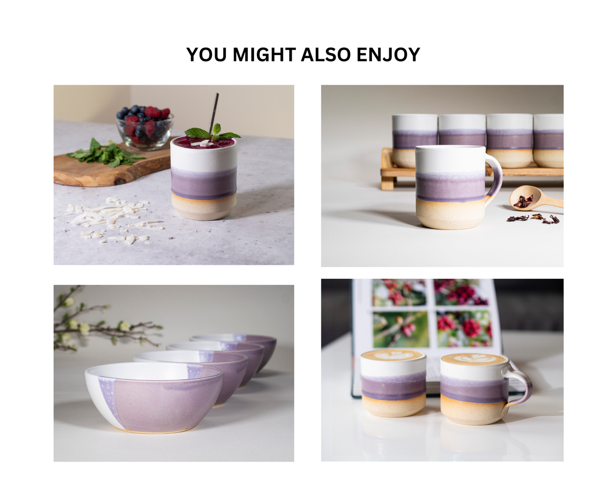 Set of purple stoneware cups on saucers, styled with coffee beans on the side.