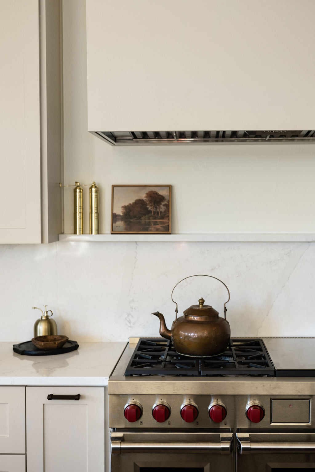 Brass and copper kettle on stovetop, with domed lid and curved handle
