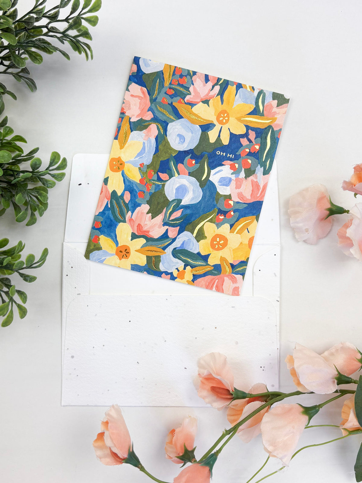 Seeded greeting card featuring a bright floral pattern cover with blank envelope