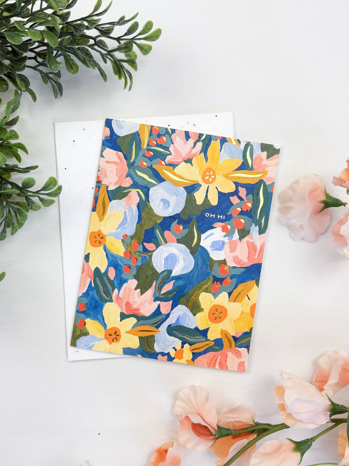 Seeded greeting card with colorful floral illustration on a blank white envelope