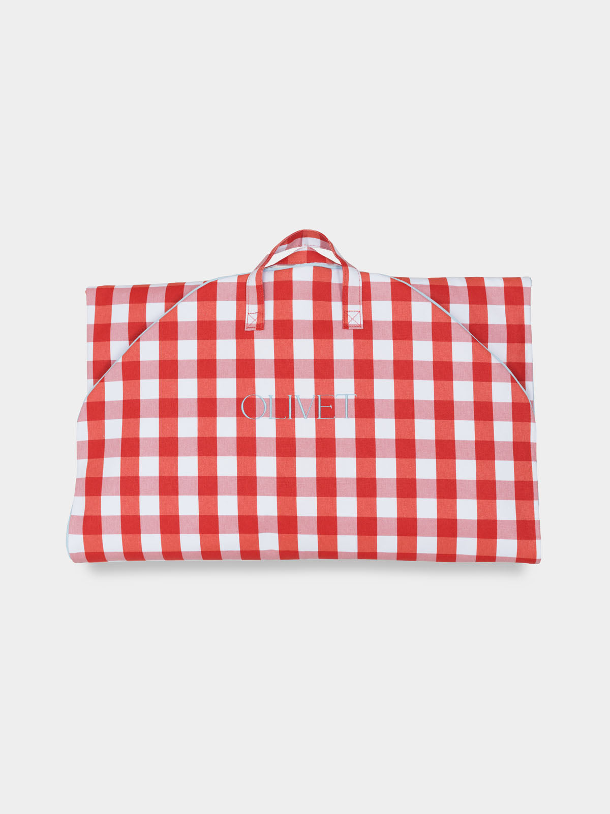 Folded red and white gingham garment bag with handles visible