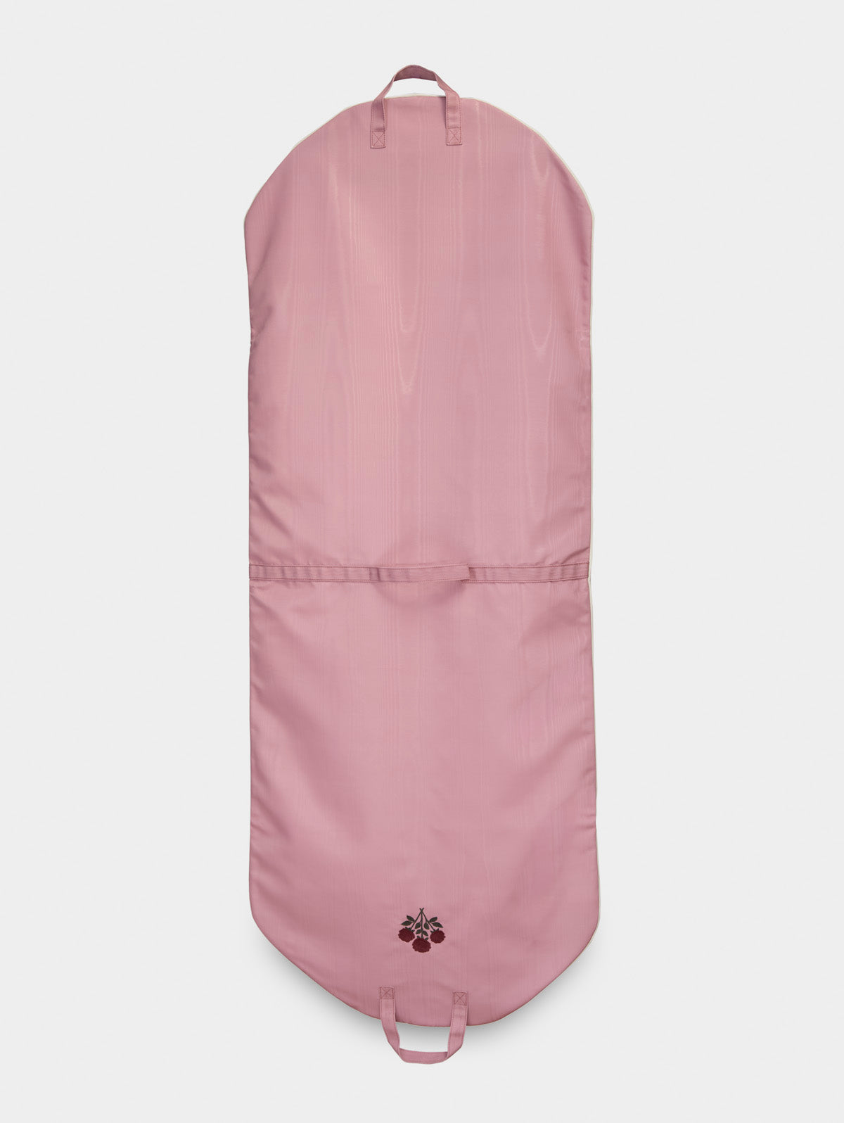 Pink garment bag with a horizontal seam, bottom handles, and floral embroidery
