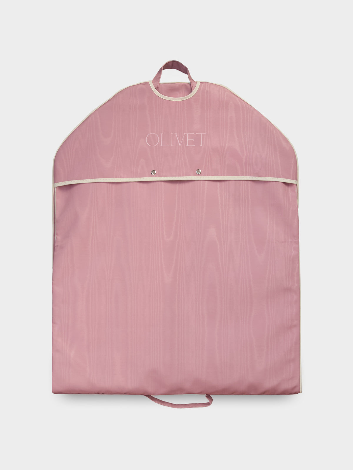 Pink garment bag with a snap-fastened top flap and pale piping