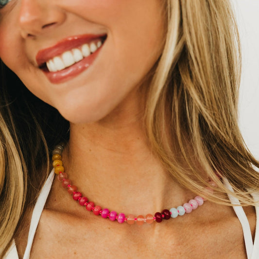 Waterproof ombre beaded necklace with pink-to-blue beads and a small dark bead accent