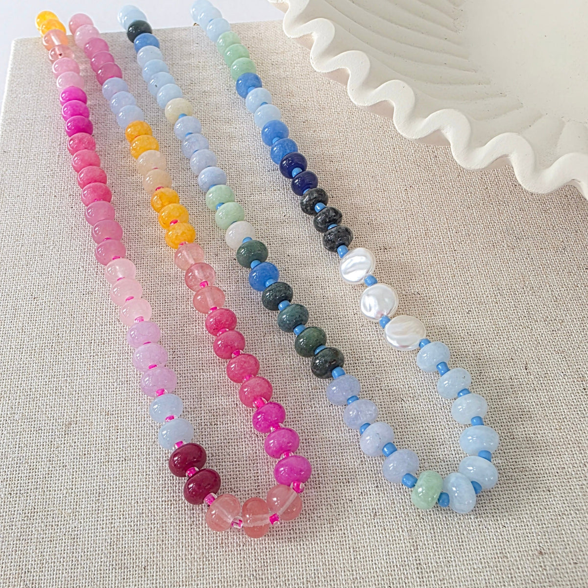 Set of waterproof ombre beaded necklaces with bright pink, blue, and pastel bead tones