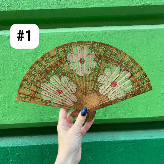 Hand-painted marbled wooden fan with dark teal, green, and red dotted stripes
