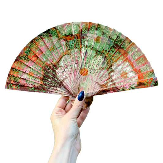 Hand-painted marbled wooden fan with peach, green, and orange geometric pattern