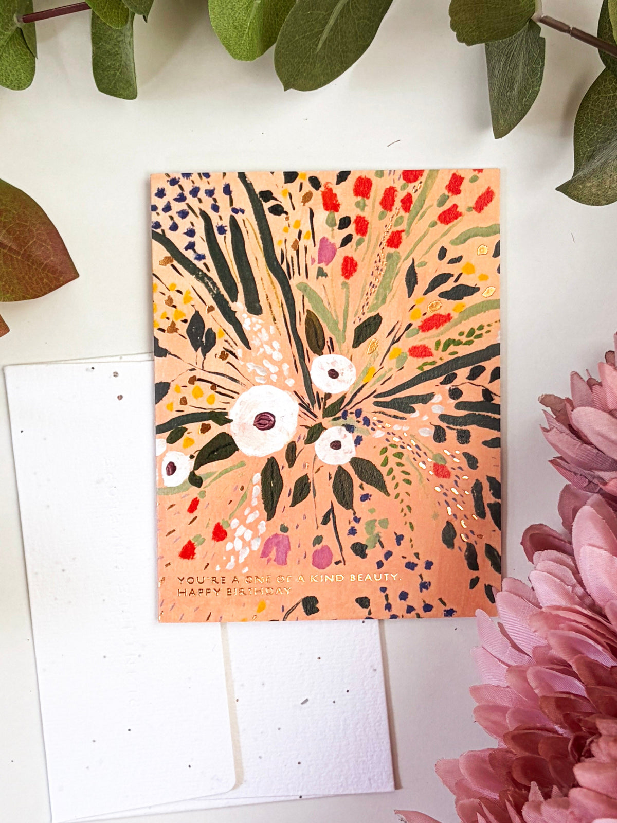 Seeded birthday card and white envelope; colorful flower burst cover