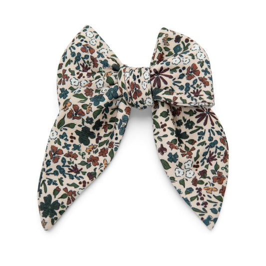 Floral hair bow with cream base and multicolor leaf-and-flower print
