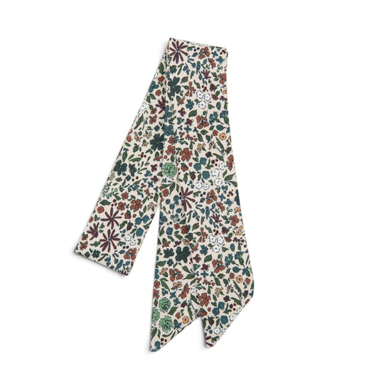 Floral hair sash with cream base and multicolor leaf and flower pattern
