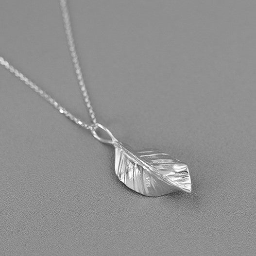 Silver leaf pendant necklace with textured leaf charm on a thin chain