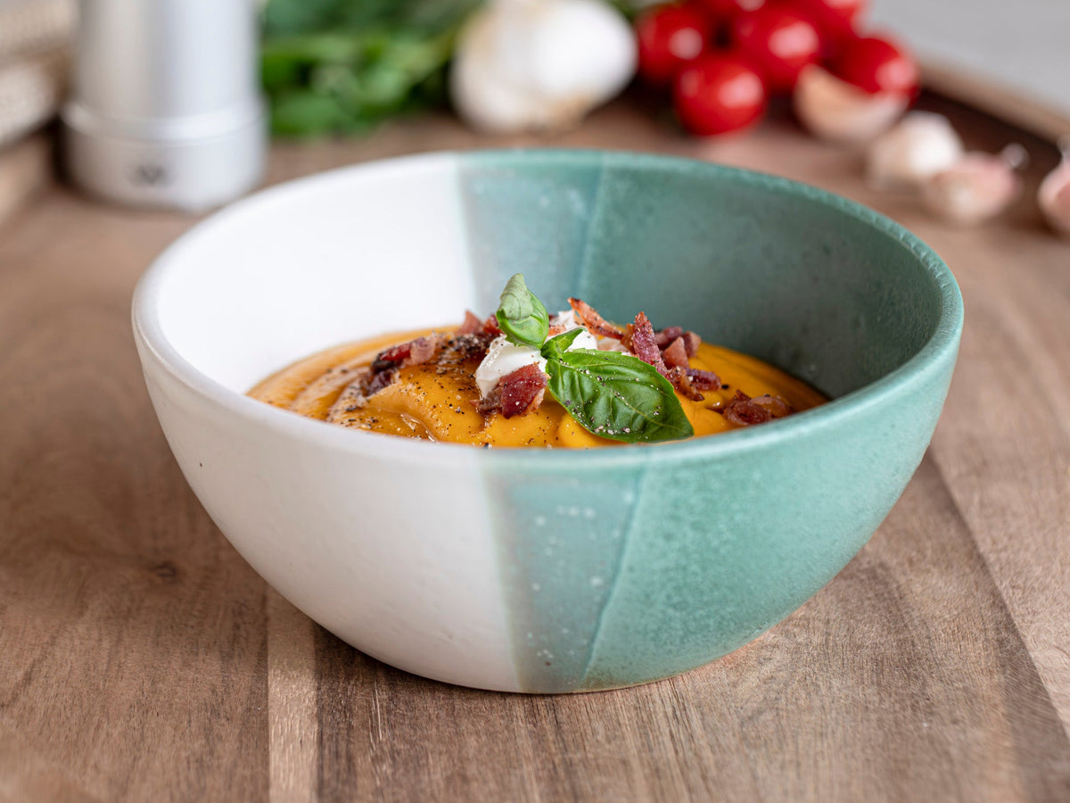 Handmade stoneware soup bowl with green speckled interior and white exterior