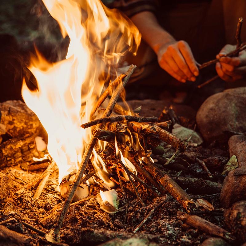 Bee's Wrap Rekindle fire starters lighting scene with flames and burning kindling