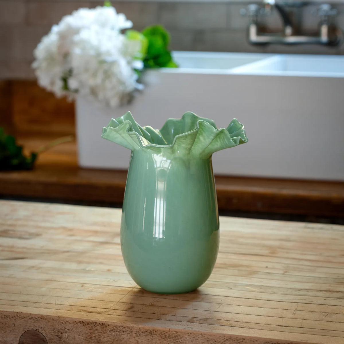 Green ceramic blossom vase with fluted ruffle top and glossy finish