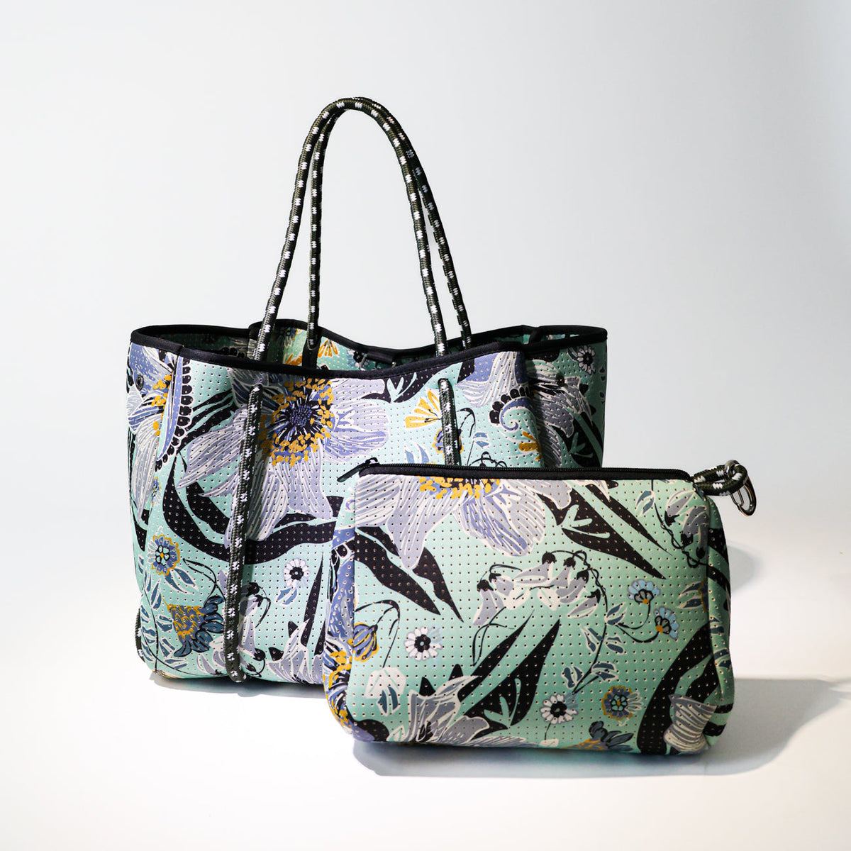 Mint floral leaf pouch with black zipper and side metal loop handle, front view