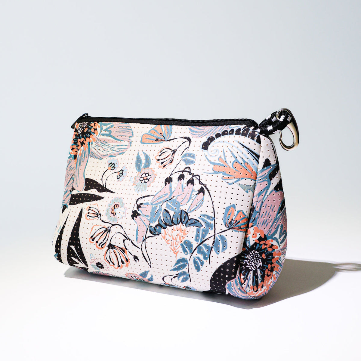 Zip-top canvas pouch with pastel blossom print and black trim, wrist keyring