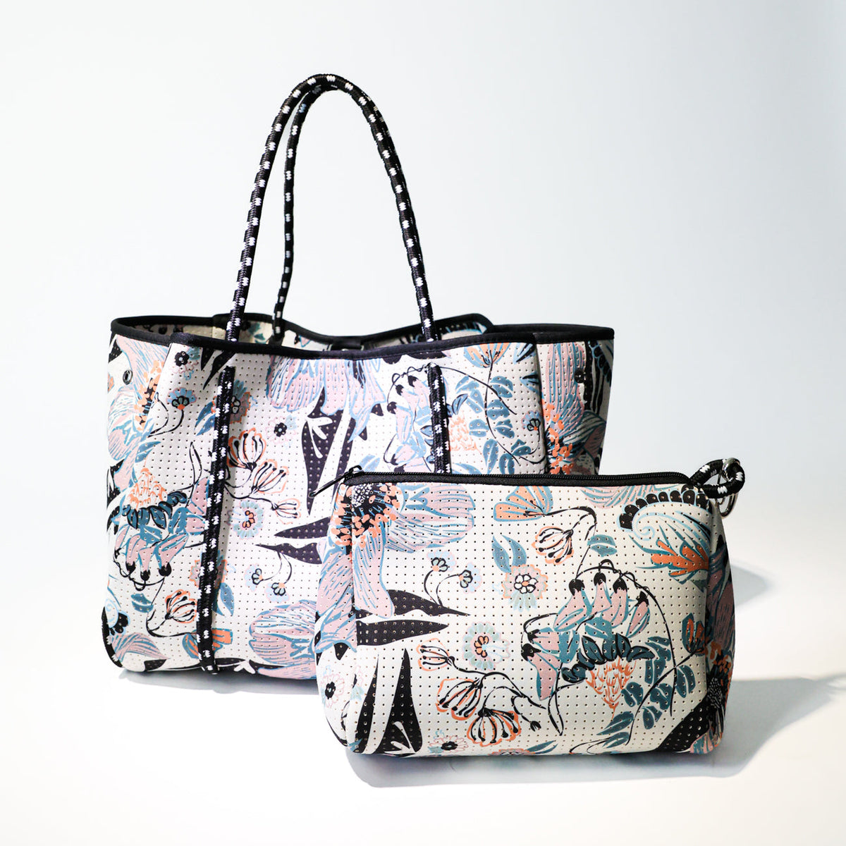 Floral-print zip-top canvas pouch with black trim and side strap detail