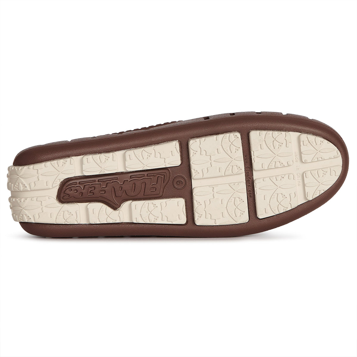 Brown slip-on clog outsole with molded tread and light tan insole detail