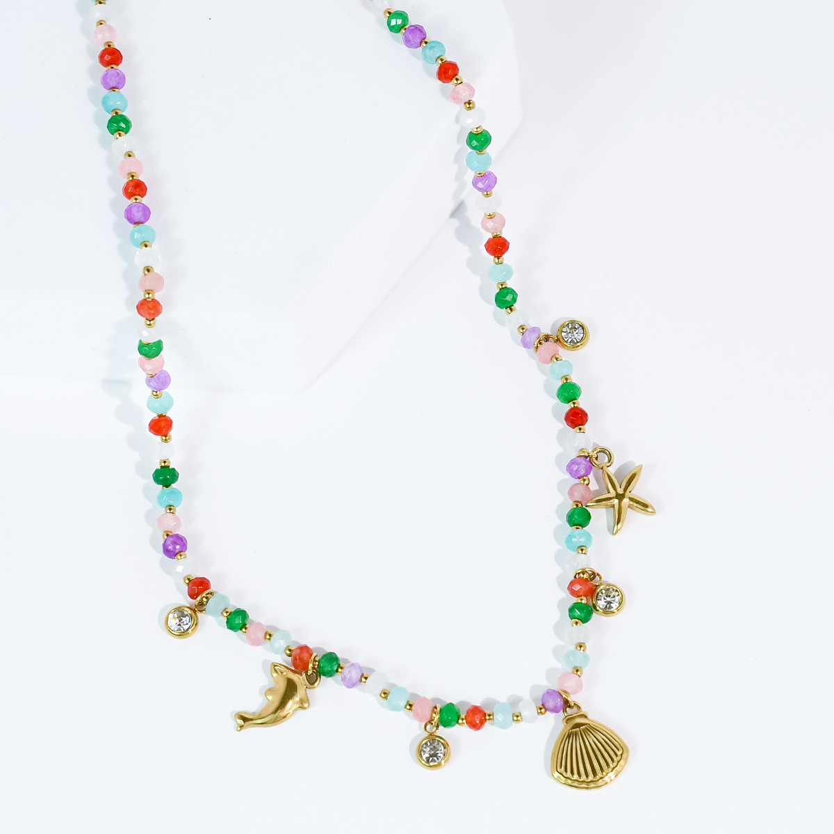 Multicolor bead necklace with gold-tone shell, starfish, dolphin and round crystal charms