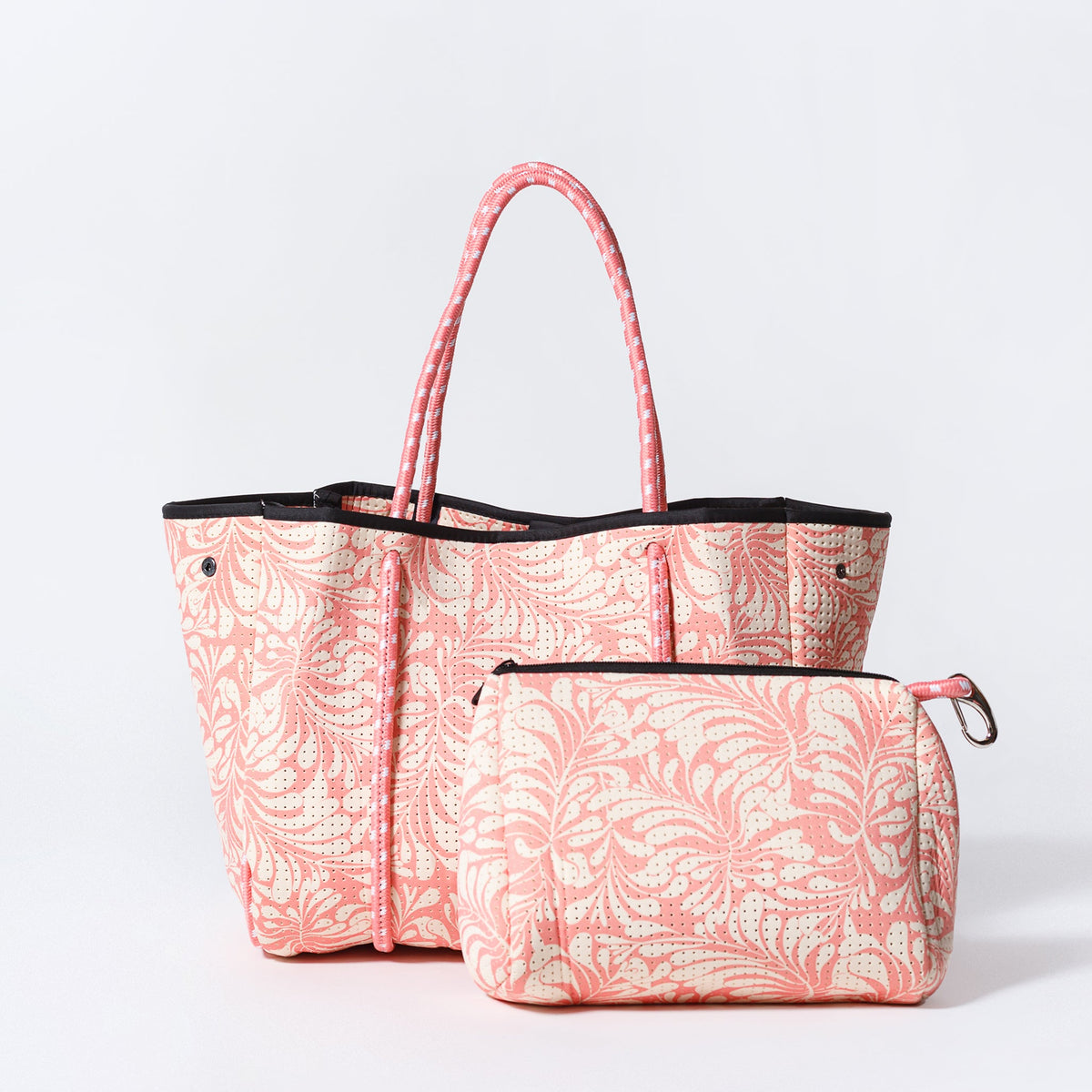 Pink patterned everyday tote with matching zip pouch, black handles and trim