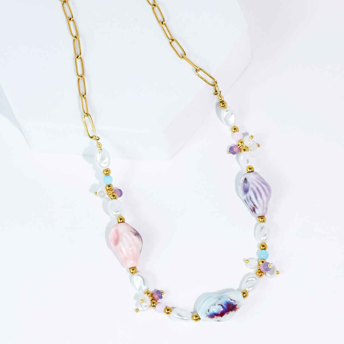 Pastel beaded necklace with gold chain, pearl beads, and purple/pink shell charms