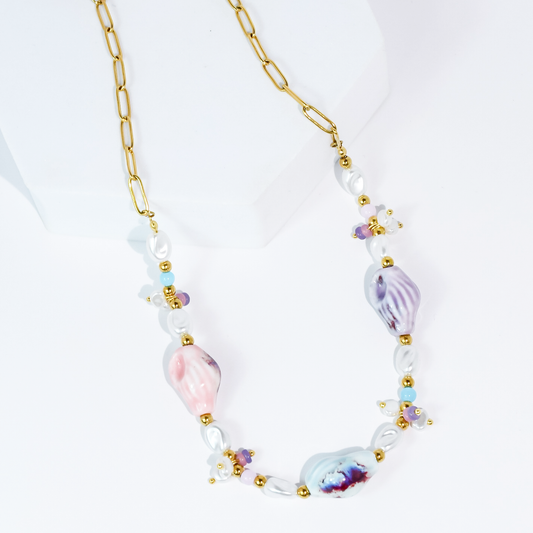 Pastel beaded necklace with gold chain, pearl beads, and purple/pink shell charms