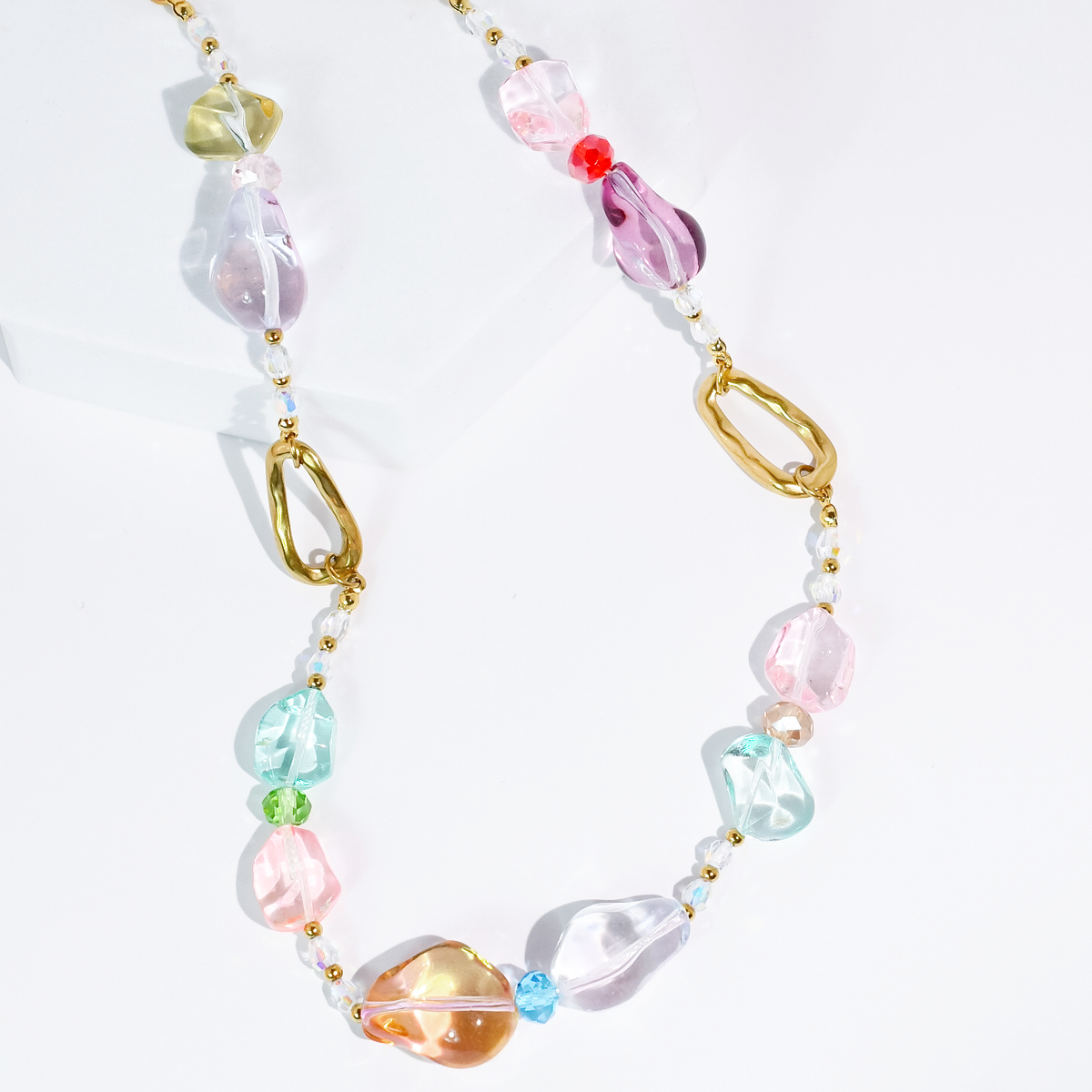 Pastel beaded necklace with gold chain and pink, blue, clear glass pebbles.